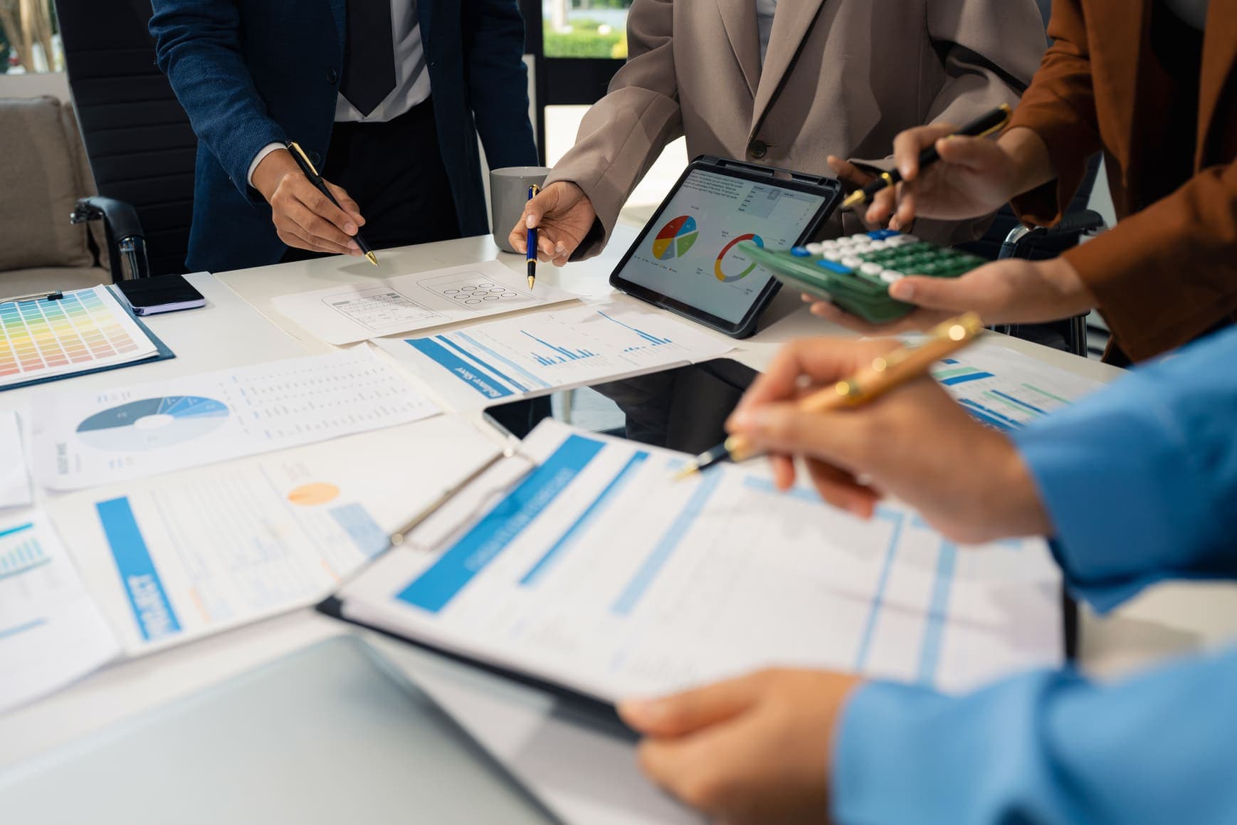 A team reviewing charts and financial reports around a table