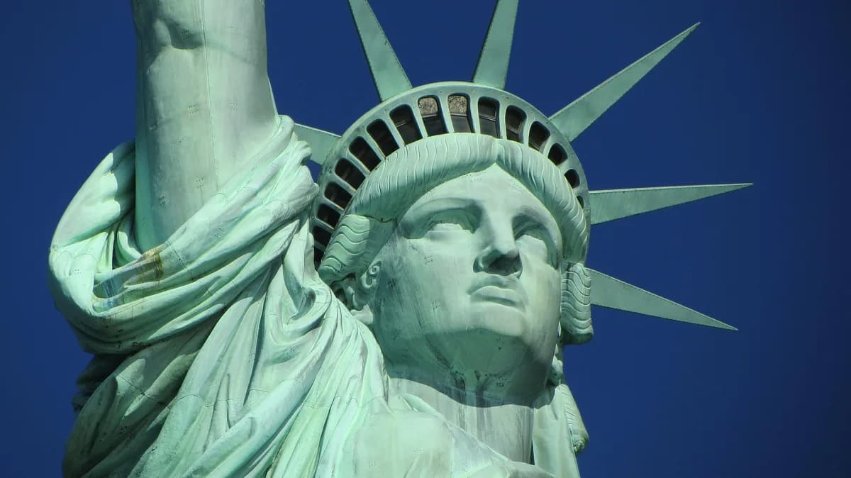 The Statue of Liberty photographed from below against a blue sky