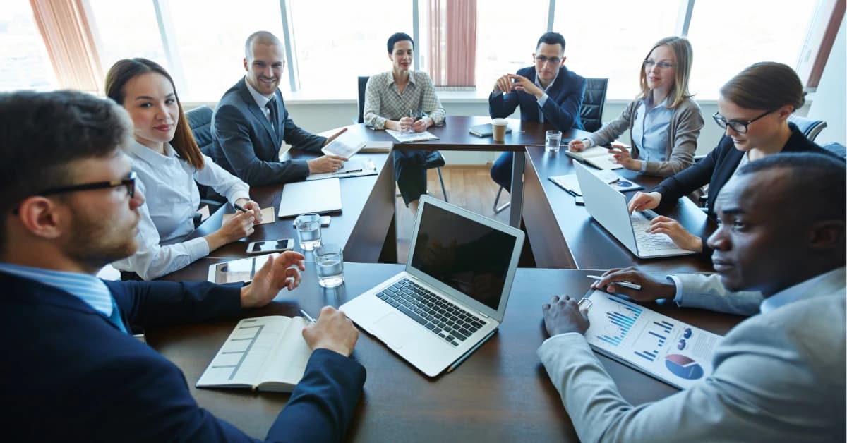 Professional meeting discussing regulation CF audit and review services for crowdfunding compliance requirements